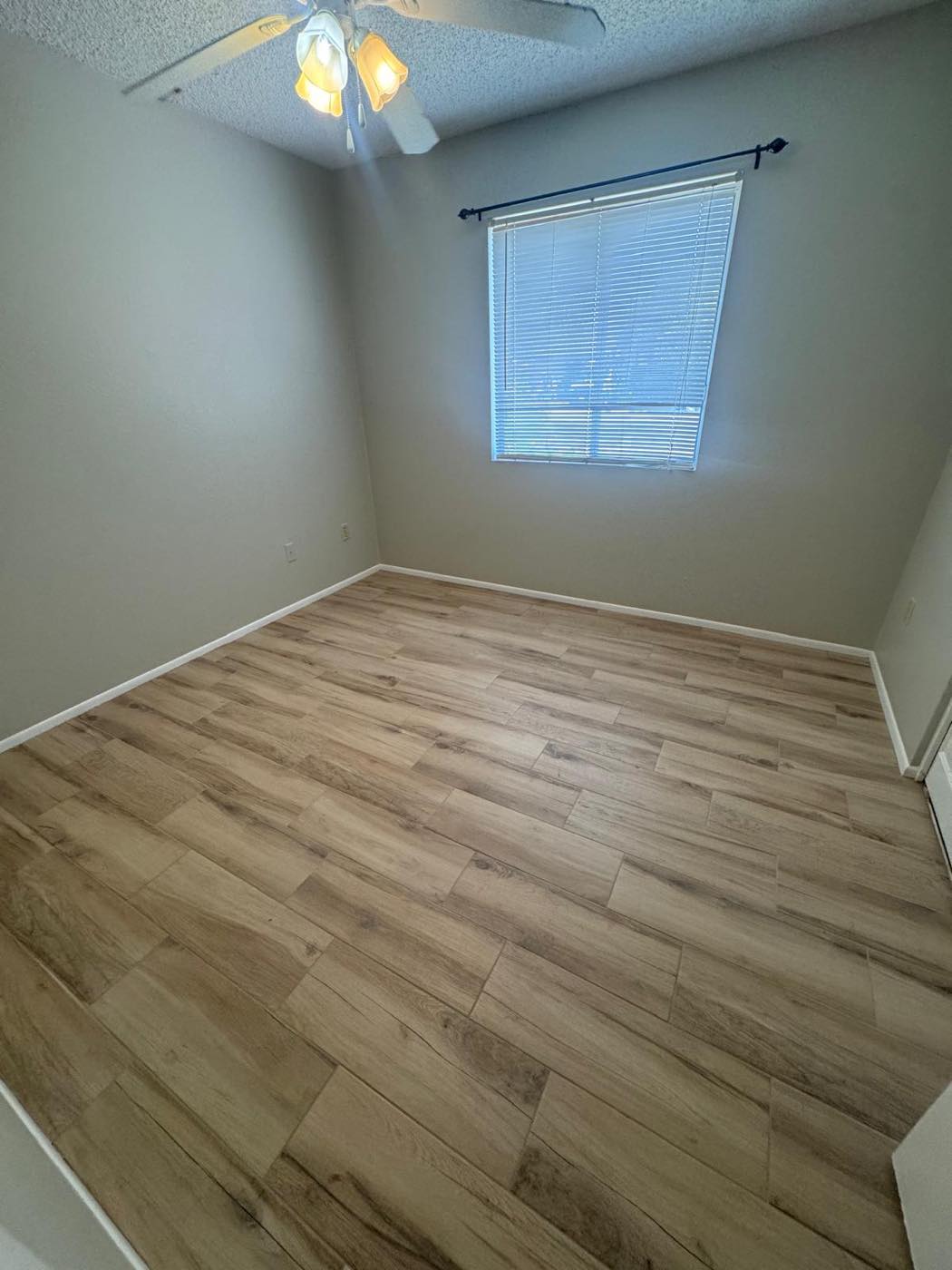 Bedroom remodel: carpet out, wood-look tile in — After